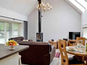 a living room with a couch and a table with a dining room at Longcroft Dairy in Oyne