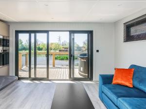 a living room with a blue couch and a sliding glass door at Mandarin Lodge - Uk51936 in Yarm