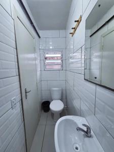 a white bathroom with a toilet and a sink at Hotel Três Passos - Prox ao Aeroporto e Rodoviária in Porto Alegre +74 photos