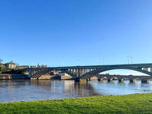 a bridge over a river with a bridge in the background at Royal Border Retreat in Berwick-Upon-Tweed