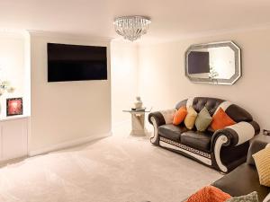 a living room with a couch and a mirror at Royal Border Retreat in Berwick-Upon-Tweed +12 photos