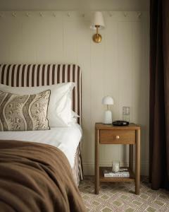 a bedroom with a bed and a side table at Domaine Golf Saint-Lazare in Limoges