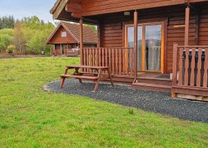a wooden bench sitting outside of a cabin at Benview Holiday Lodges in Gartmore