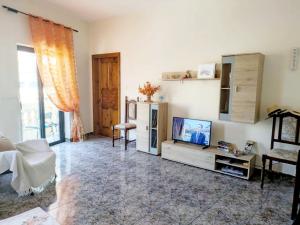 a living room with a tv and a couch at Silia's Maisonette in Marsaskala