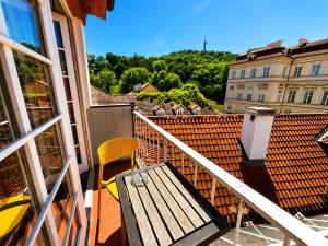 ein Balkon mit einer Holzbank und ein Gebäude in der Unterkunft LH Vintage Design Hotel Sax in Prag