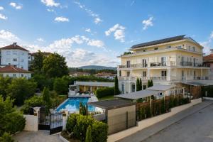 a large white building with a swimming pool at Aleksov Complex Sans Souci in Ognyanovo