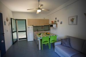 a kitchen with a table and a couch in a room at Residenze Sant'Andrea in Isca Marina