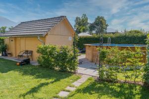 a backyard with a shed and a pool at Apartments Roberta in Bled