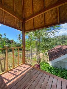 a view from the porch of a house with a deck at Bayan Exotic Homestay in Senaru