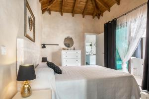 a bedroom with a white bed and a window at Villa La Era 1 in El Cotillo +17 photos