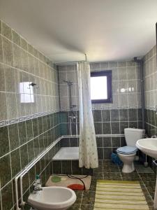 a bathroom with a tub and a toilet and a sink at Casa in inima Bucovinei in Câmpulung Moldovenesc +27 photos