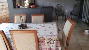 a table with chairs and a table cloth with an owl on it at Pensão por do sol in Ribeirão Preto