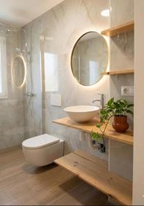 a bathroom with a sink and a toilet and a mirror at Loft A el Ramellet in Alginet