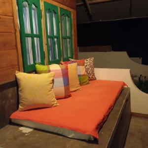 a bed with colorful pillows on top of it at Salt Bay Kite and Dive Resort in Kalpitiya +40 photos