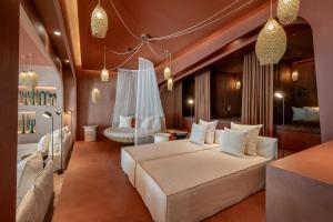 a bedroom with a large white bed in a room at Seezeitlodge Hotel & Spa in Gonnesweiler +42 photos
