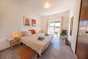 a bedroom with a large bed and a window at Local Guesthouse in Sagres +54 photos