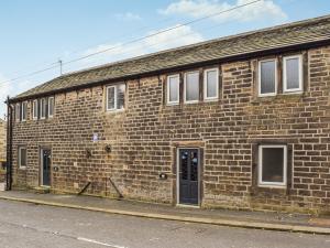 a brick building on the side of a street at Mount View - Uk48425 in Holmfirth