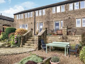 a brick building with a table in front of it at Trough Cottage - Uk48424 in Holmfirth +15 photos