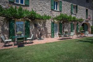 a patio with chairs and tables in front of a building at Preseglie Lake Garda in Desenzano del Garda