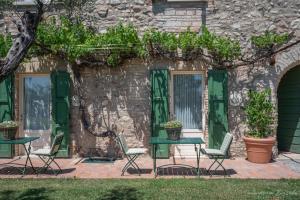 a table and chairs in front of a stone building at Preseglie Lake Garda in Desenzano del Garda +111 photos