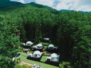 an aerial view of a building in the woods at TOCORO. Mt.Fuji CAMP&GLAMPING in Fujikawaguchiko +225 photos
