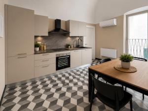 a kitchen with a table and a dining room at Cà di Righe in Pietra Ligure