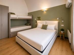 a bedroom with a bed and two bunk beds at Cà di Righe in Pietra Ligure