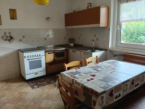 a kitchen with a table with a table cloth on it at Casa Defrancesco - with terrace in Moena