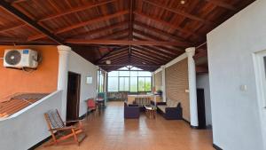 a large living room with a ceiling with wooden beams at Melvila in Colombo