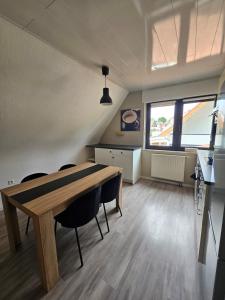 a large room with a wooden table and chairs at FeWo Zimmer Waldmohr in Waldmohr