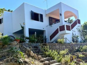 a white house with stairs in front of it at Villa Sa Guaita in Sant Josep de sa Talaia