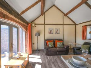 a living room with a couch and a table at Cart House Barn - Uk49802 in Morville
