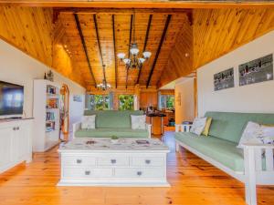 a living room with two green couches and a table at Rivers End Farm Stanford - Cabins in Stanford