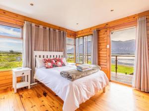 a bedroom with a bed in a room with windows at Rivers End Farm Stanford - Cabins in Stanford