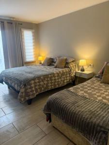 a bedroom with two beds and a window at Punta Luna in La Serena