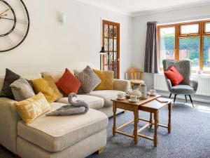 a living room with a couch and a table at Dippers in Smallburgh