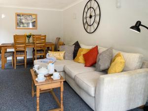 a living room with a couch and a table at Dippers in Smallburgh