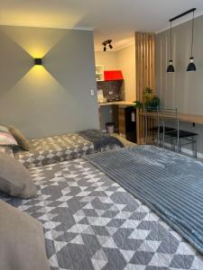 a bedroom with a large bed and a kitchen at Punta Luna in La Serena