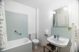 a white bathroom with a sink and a toilet at Hotel de la Bonnheure in Bracieux +51 photos