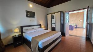 a bedroom with a bed and a door to a patio at Melvila in Colombo +57 photos