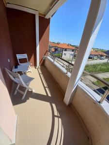 a balcony with a chair and a table and a view at Къща за гости "Адам и Ева" in Kavarna +8 photos