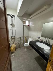 a bathroom with a sink and a toilet at Daisy Cottage in Murree +25 photos
