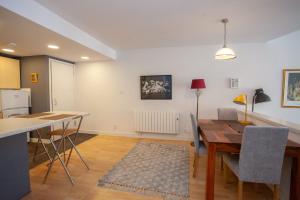 a kitchen and dining room with a table and chairs at The Art Flat Glasgow in Glasgow