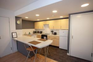 a kitchen with a table and a white refrigerator at The Art Flat Glasgow in Glasgow