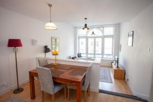 a dining room with a wooden table and chairs at The Art Flat Glasgow in Glasgow