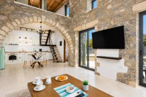 a kitchen and living room with a stone wall at La Casa Di Pietre 3 in Kiotari