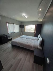 a bedroom with a large bed in a room at Къща за гости "Адам и Ева" in Kavarna