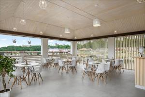 a restaurant with tables and chairs and windows at Serenity in Solotvyno