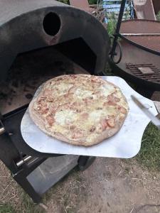a pizza sitting on top of a grill at Tente Cocoon in La Brillanne