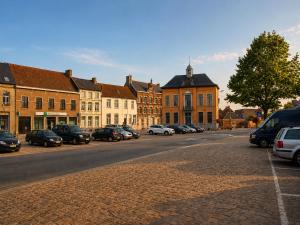 a city street with cars parked on the side of the road at Les lodges d'Eva de Chièvres in Chièvres